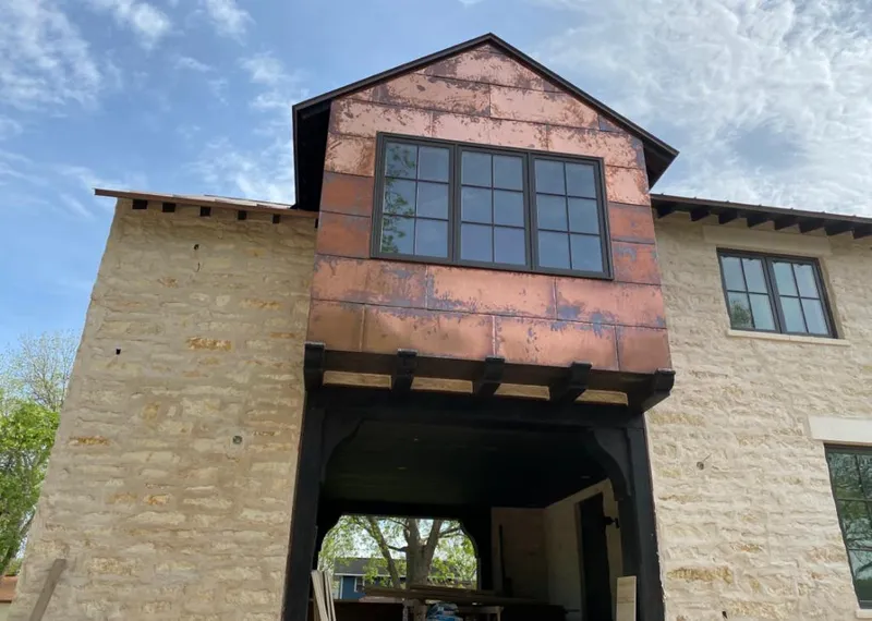 Copper metal panel facade on a stone building for Skylight Installation in Wood River